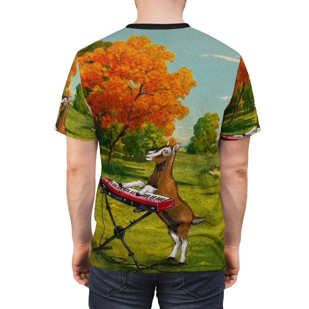 A t-shirt design featuring a goat playing a keyboard in a meadow, with the text "Practicing In The Meadow" - men back