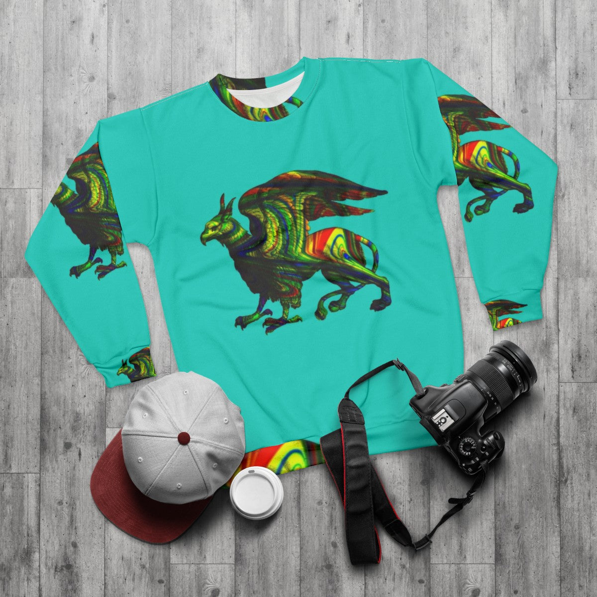 Colorful abstract griffin aqua sweatshirt with mythical creature silhouette art - flat lay