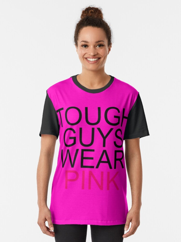 Graphic T-shirt with the text "rgv8r infected tough guys wear pink" on a pink background - Women