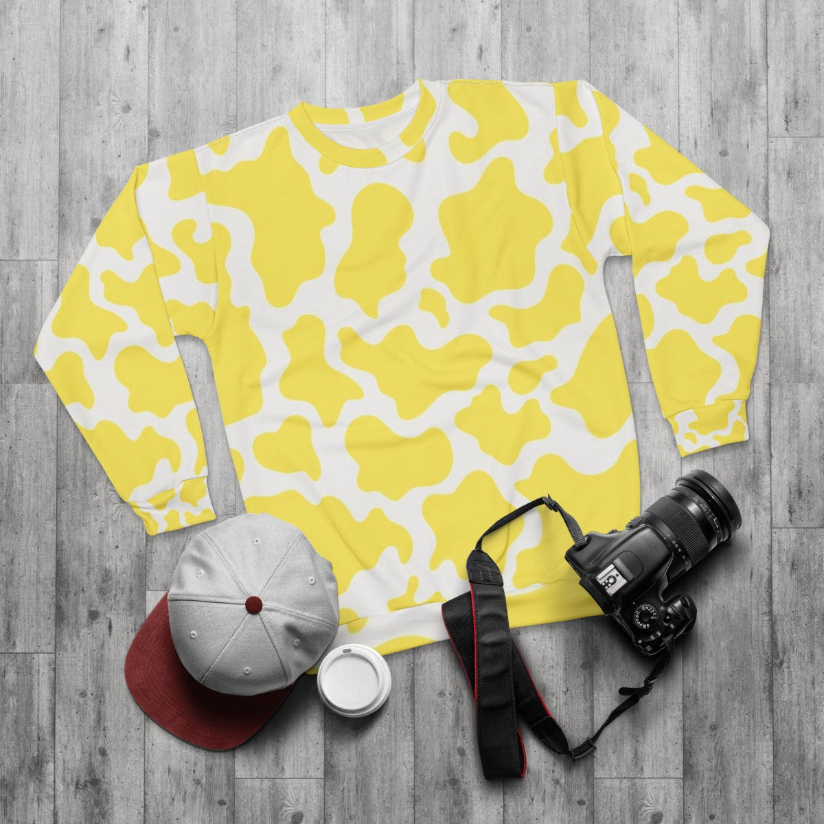 Yellow cow print sweatshirt with textured animal skin pattern - flat lay