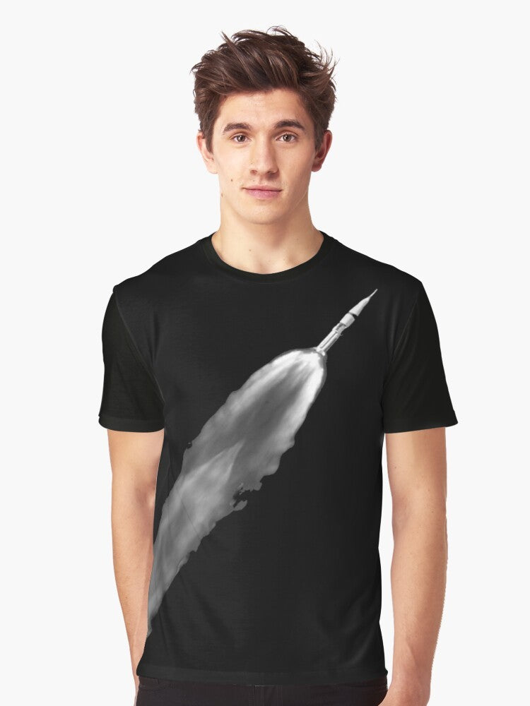 Graphic t-shirt with a rocket launch design, featuring the Saturn V rocket and space elements. - Men