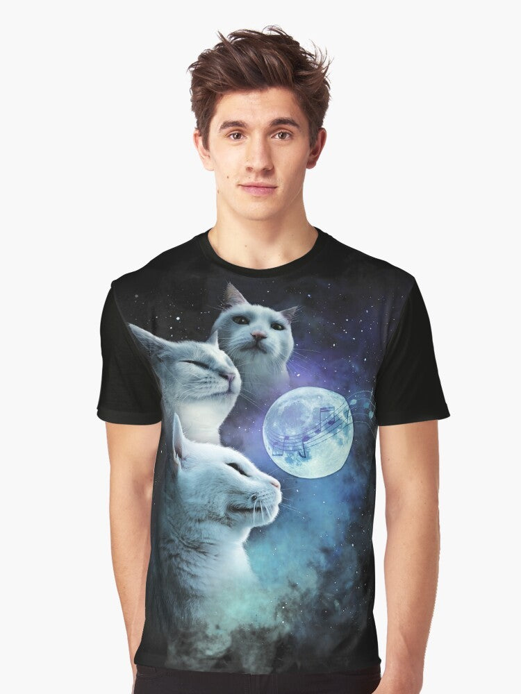 A graphic t-shirt featuring a cat vibing to music in a cosmic, galaxy-themed design with three cats and a moon. - Men