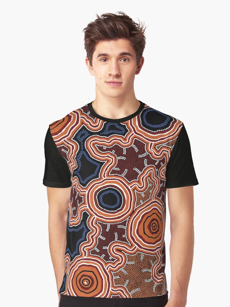 Authentic Aboriginal Art Pathways to Water Graphic T-Shirt featuring traditional indigenous artwork with dots, kangaroos, emus, and earth tones. - Men