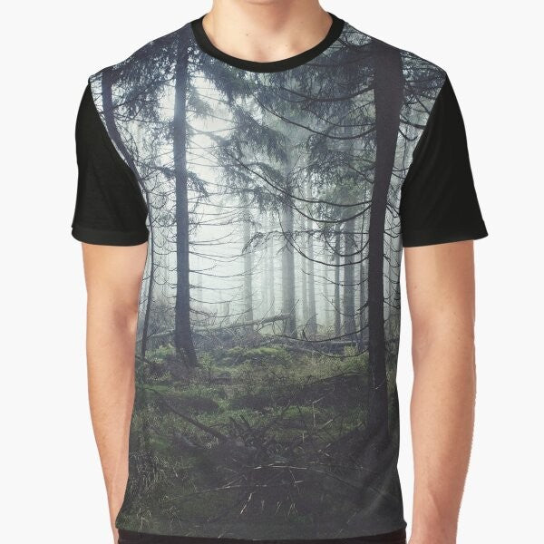 A vintage-inspired graphic t-shirt featuring a misty, foggy forest landscape with trees and mountains, perfect for nature and adventure lovers.