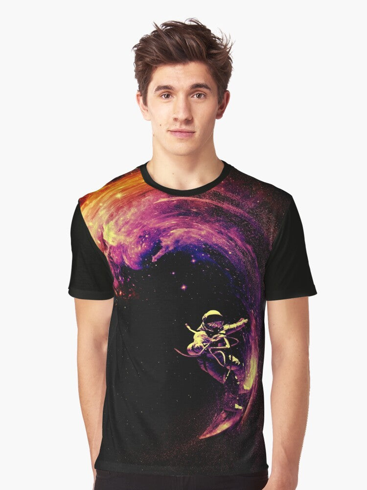 A colorful graphic t-shirt featuring an astronaut surfing through a cosmic galaxy with stars and planets in the background. - Men