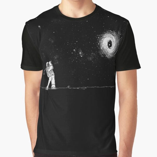 A graphic t-shirt featuring a black hole in one golf design, against a space and star-filled background.