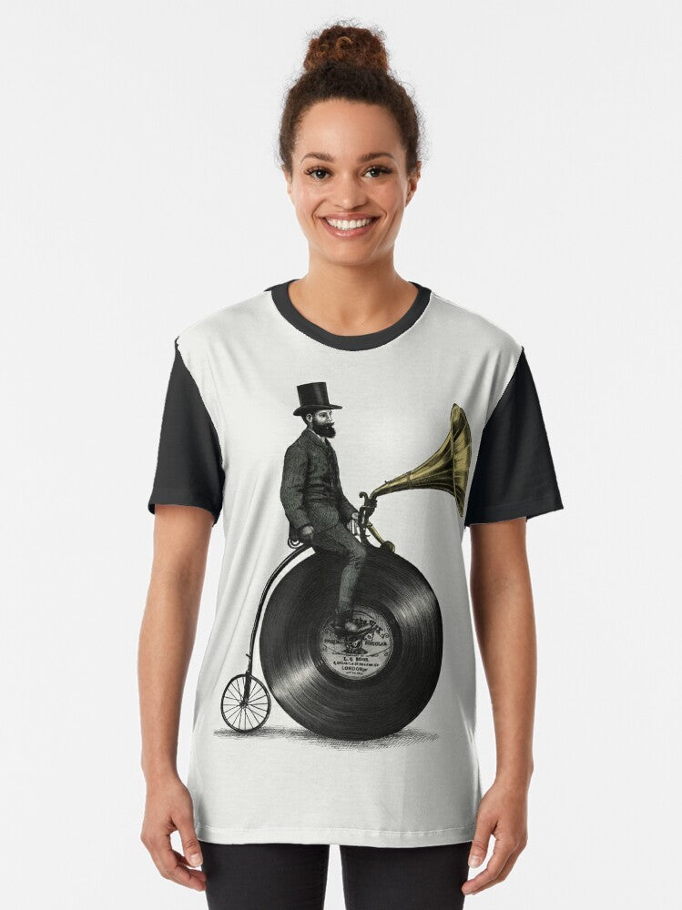 Vintage-inspired graphic t-shirt with music and cycling motifs, featuring a man with a top hat, beard, and moustache riding a penny farthing bicycle. - Women