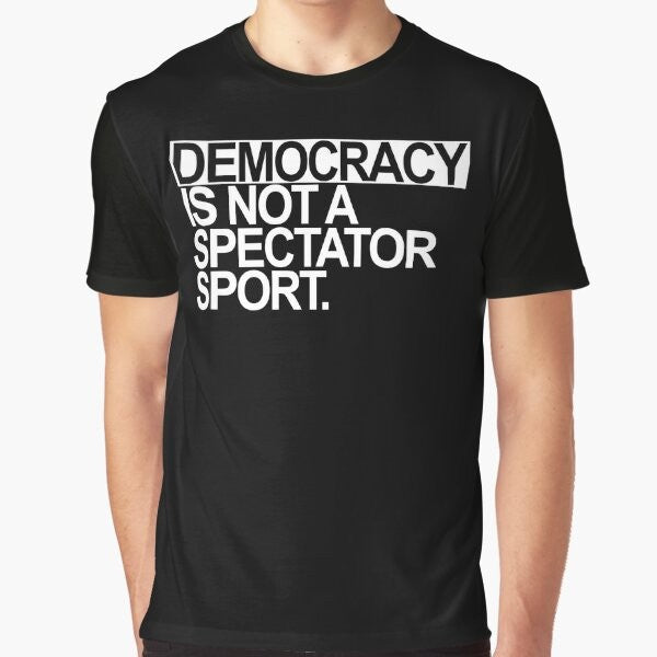 A white t-shirt with the text "Democracy is NOT a Spectator Sport" in bold, black letters.