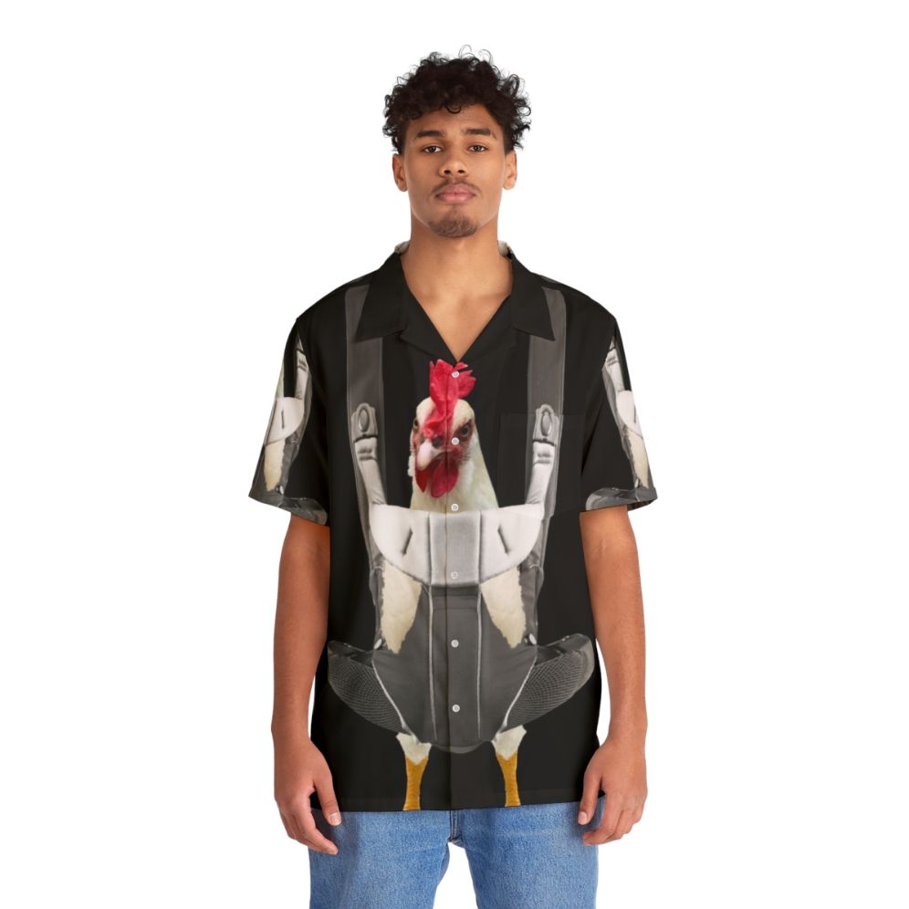 Chicken in baby carrier wearing a Hawaiian shirt - People Front