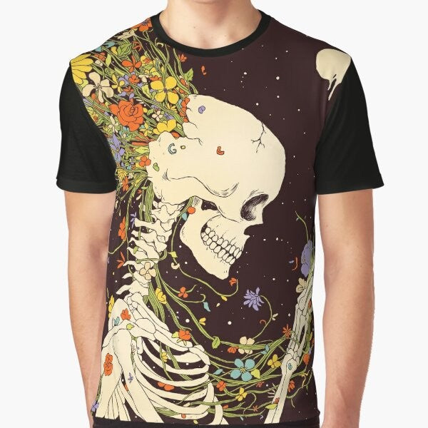 Surreal graphic t-shirt featuring a skull and skeleton design with floral and celestial elements, representing the beauty and impermanence of existence.