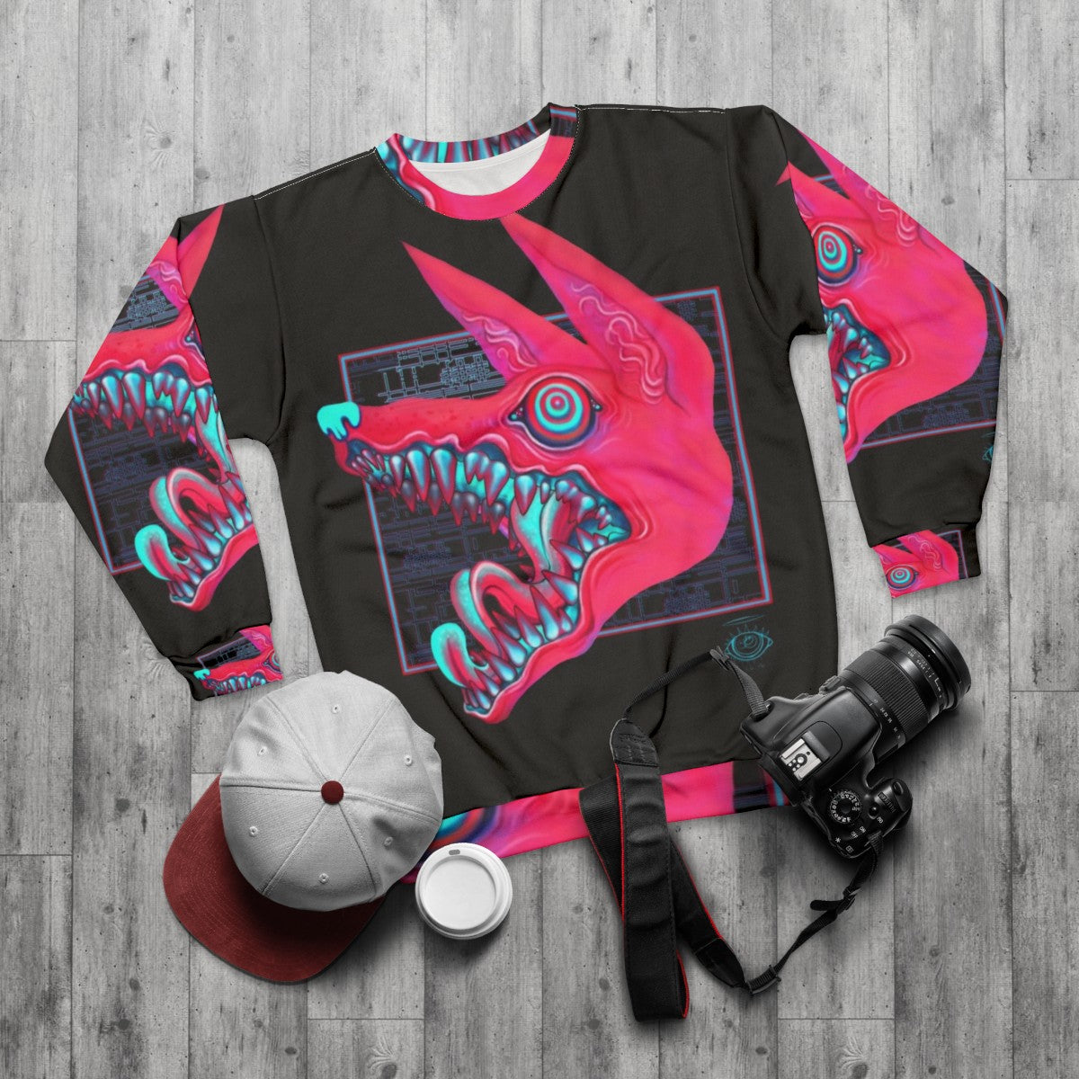 Creepy canine sweatshirt with pastel colored teeth and eyes - flat lay