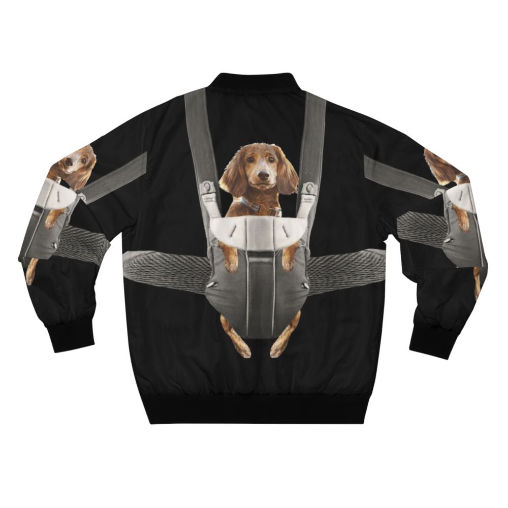 Adorable dachshund wearing a bomber jacket and sitting in a baby carrier, creating a funny and cute scene. - Back