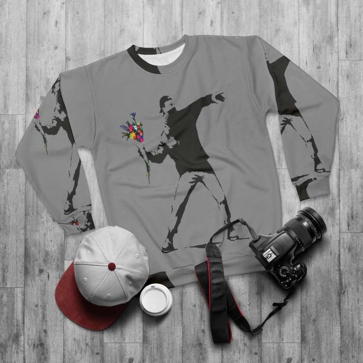 Banksy inspired sweatshirt featuring protester throwing flowers graphic - flat lay