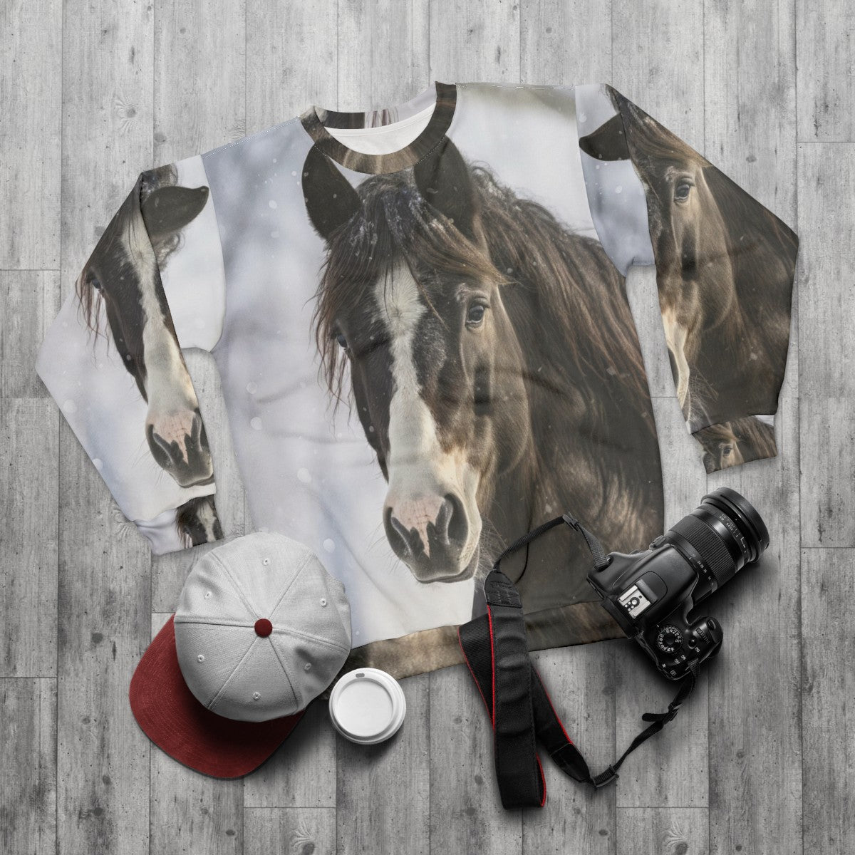 Black horse silhouette in winter scene on sweatshirt - flat lay