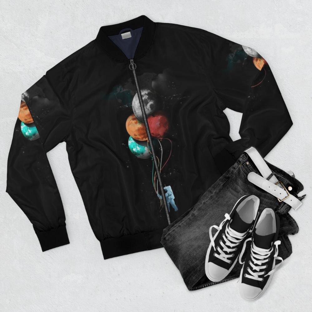 Spaceman's Cosmic Bomber Jacket with Planets, Balloons, and Surreal Elements - Flat lay