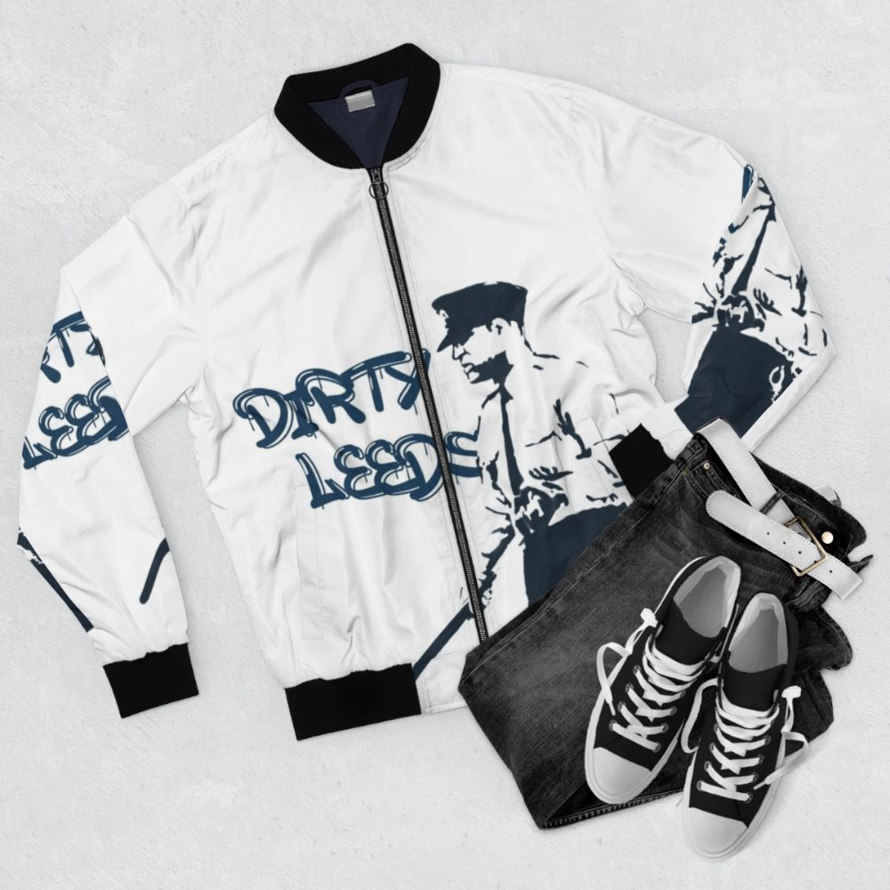 Leeds United bomber jacket with "Dirty Leeds" text - Flat lay