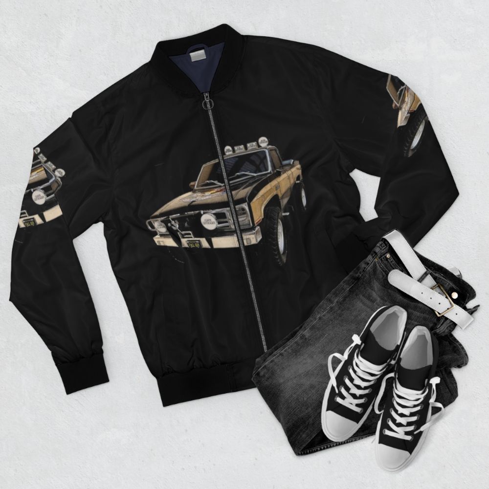 A bomber jacket inspired by the TV series "The Fall Guy" featuring the GMC Sierra Grande truck - Flat lay