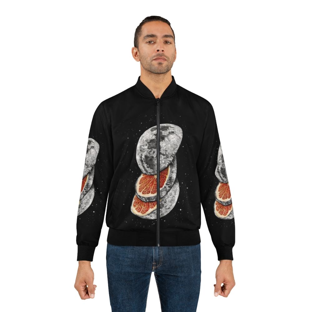 A unique bomber jacket featuring a surreal print of a moon and space-themed fruit design - Lifestyle