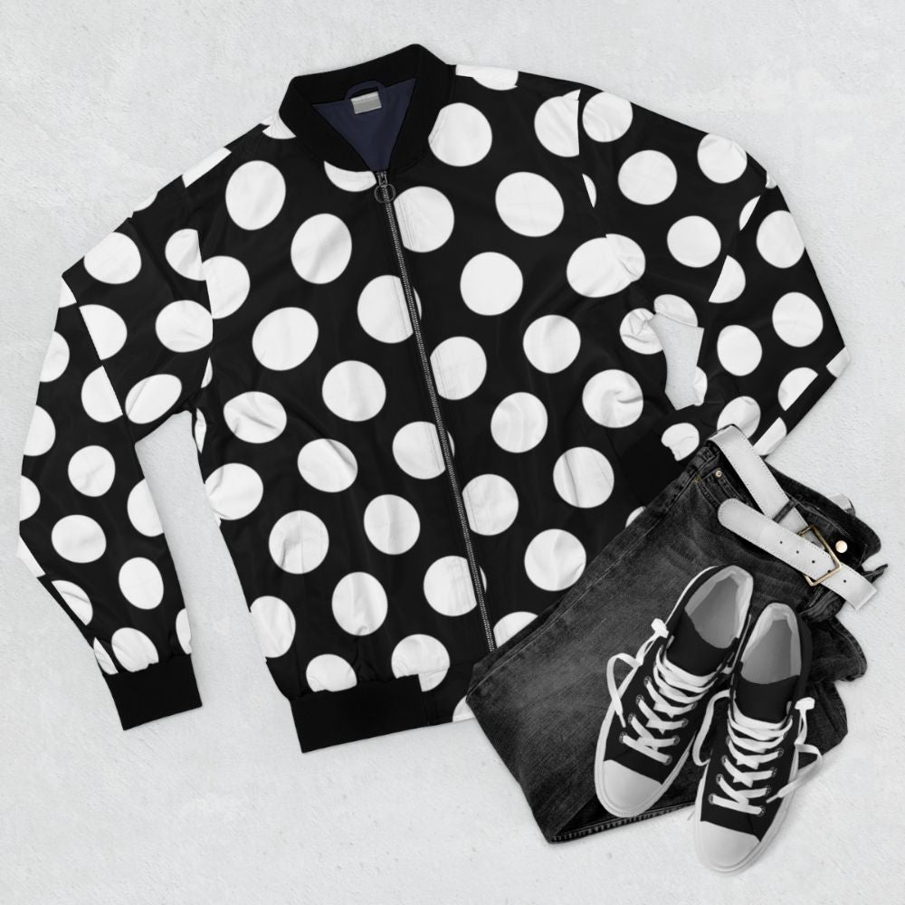 Black bomber jacket with large white polka dot pattern - Flat lay