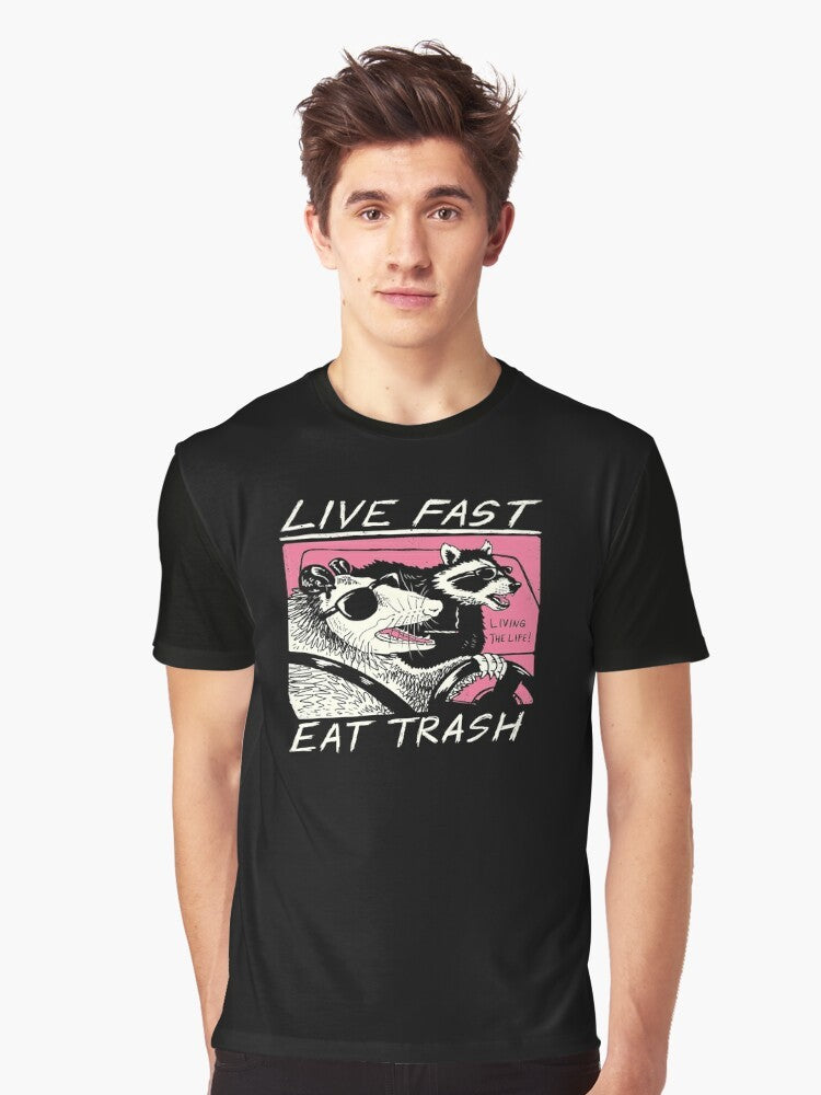 A graphic t-shirt with a live fast, eat trash design featuring a raccoon in a retro-style illustration. - Men