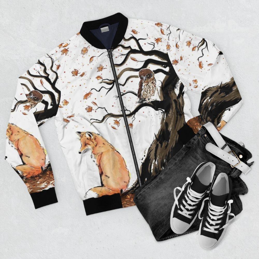 Autumn nature watercolor bomber jacket with fox, owl, and bird designs - Flat lay