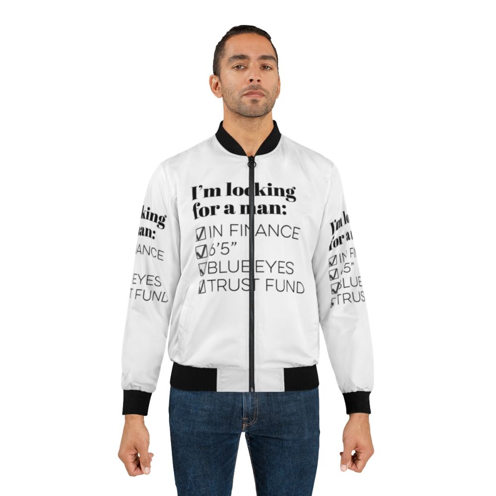 A blue bomber jacket with the text "I'm looking for a man in finance" on it, representing the TikTok song and humor for single people. - Lifestyle