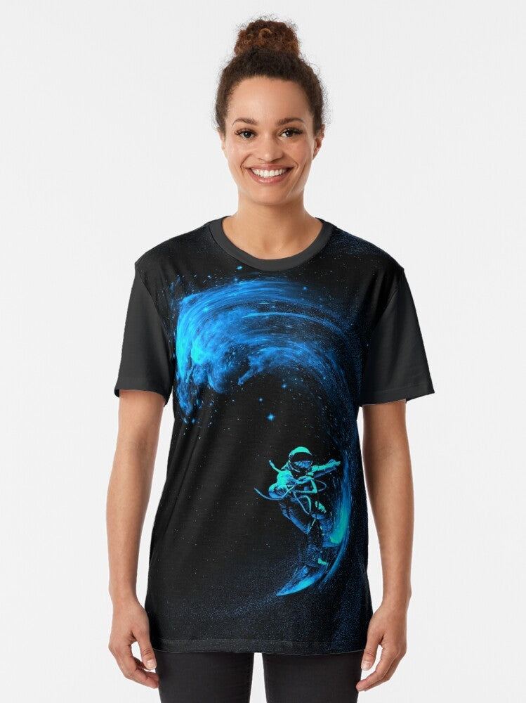 A graphic t-shirt design featuring an astronaut surfing through a colorful, cosmic galaxy filled with stars and swirling nebulas. - Women