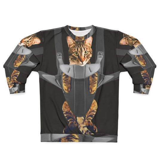 Cute tabby cat in a baby carrier on a sweatshirt