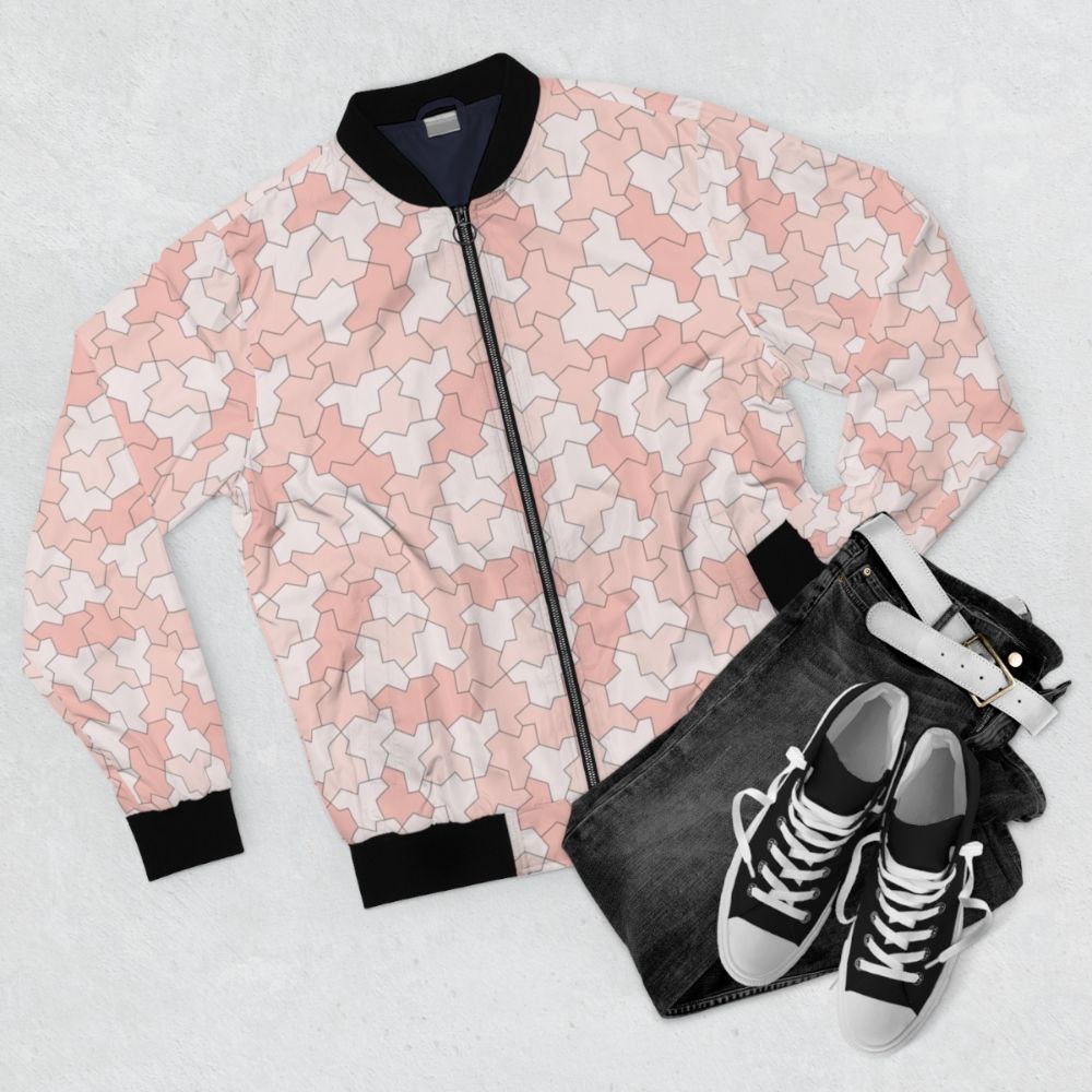 Geometric bomber jacket featuring aperiodic monotile Einstein shapes in peach and pink tones - Flat lay