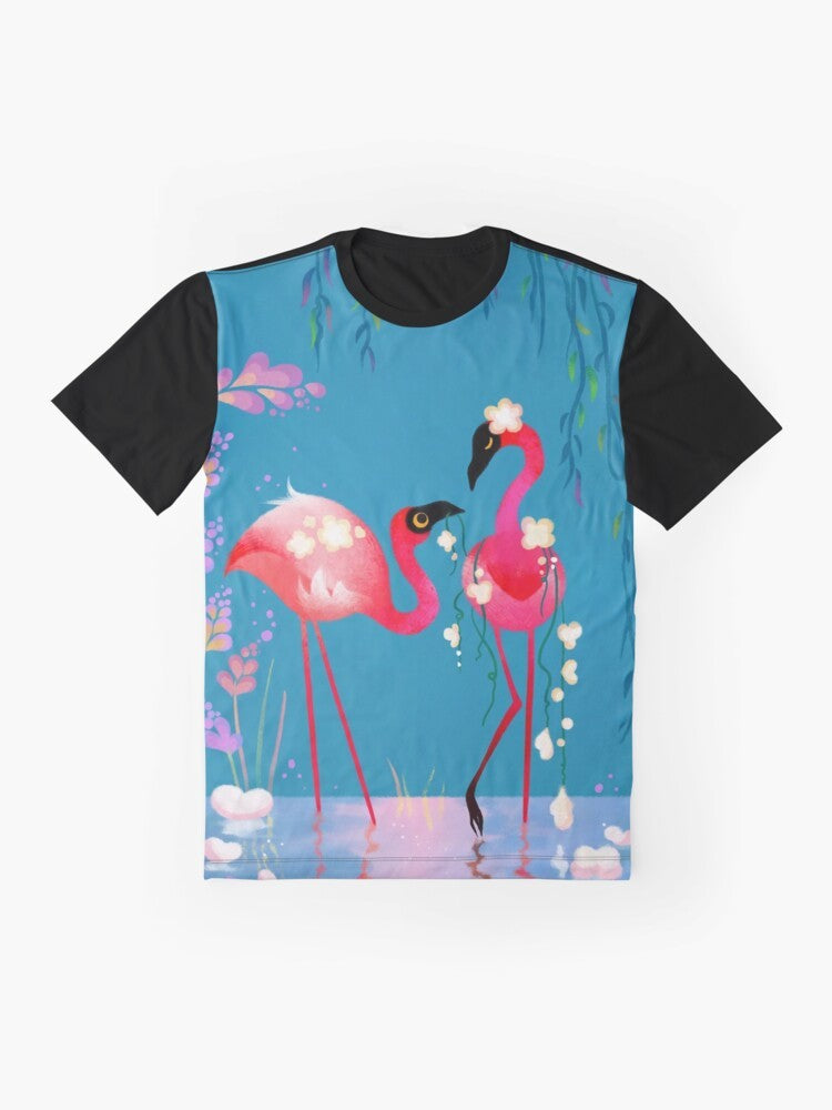 Colorful graphic design of a flamingo bird surrounded by vibrant flowers and foliage on a t-shirt. - Flat lay