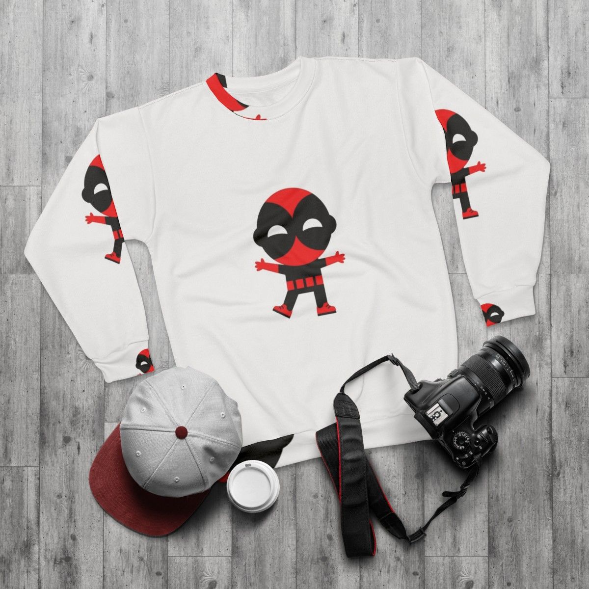 Cute baby wearing a superhero-themed sweatshirt - flat lay