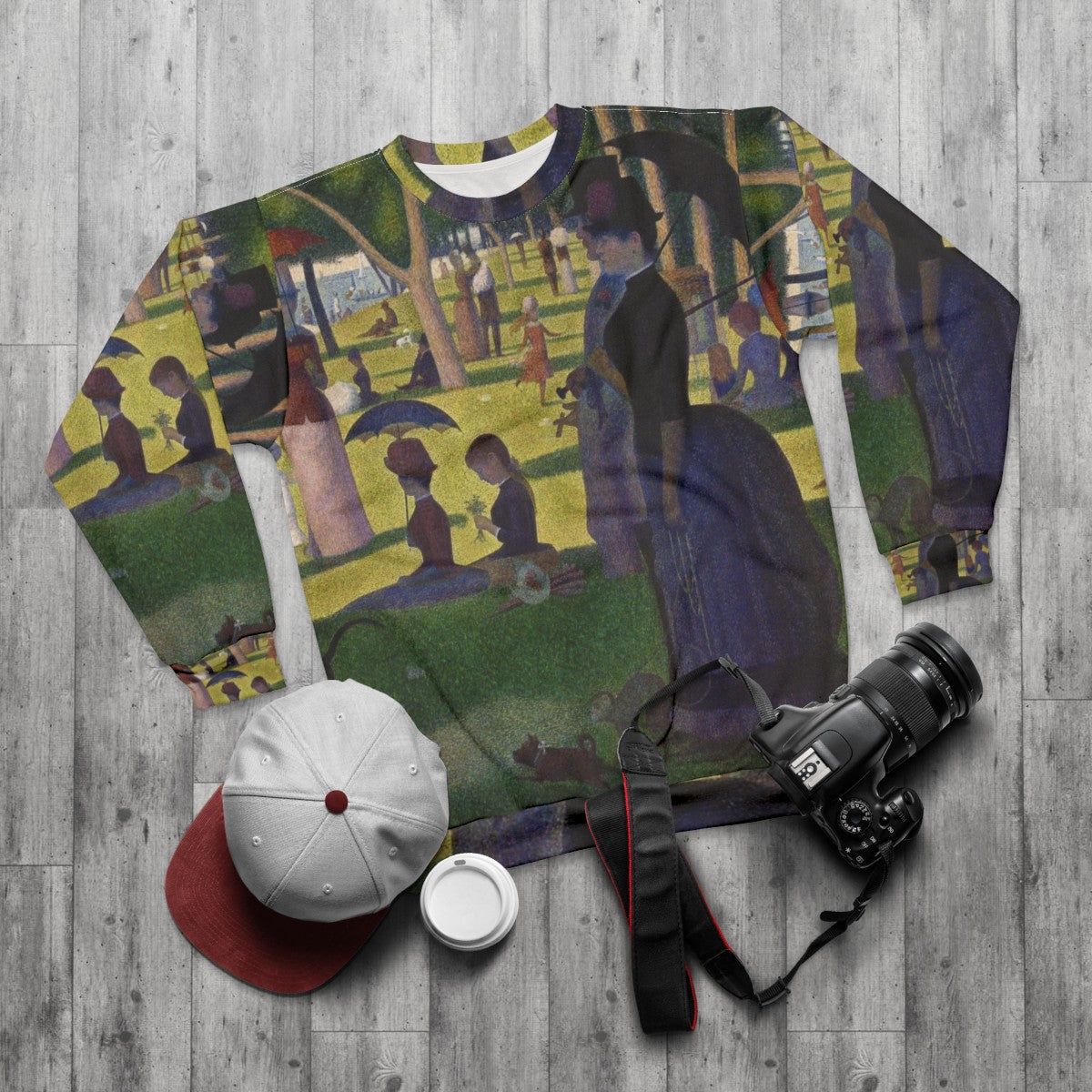 Sweatshirt featuring pointillist art inspired by Georges Seurat's Sunday Afternoon on La Grande Jatte - flat lay