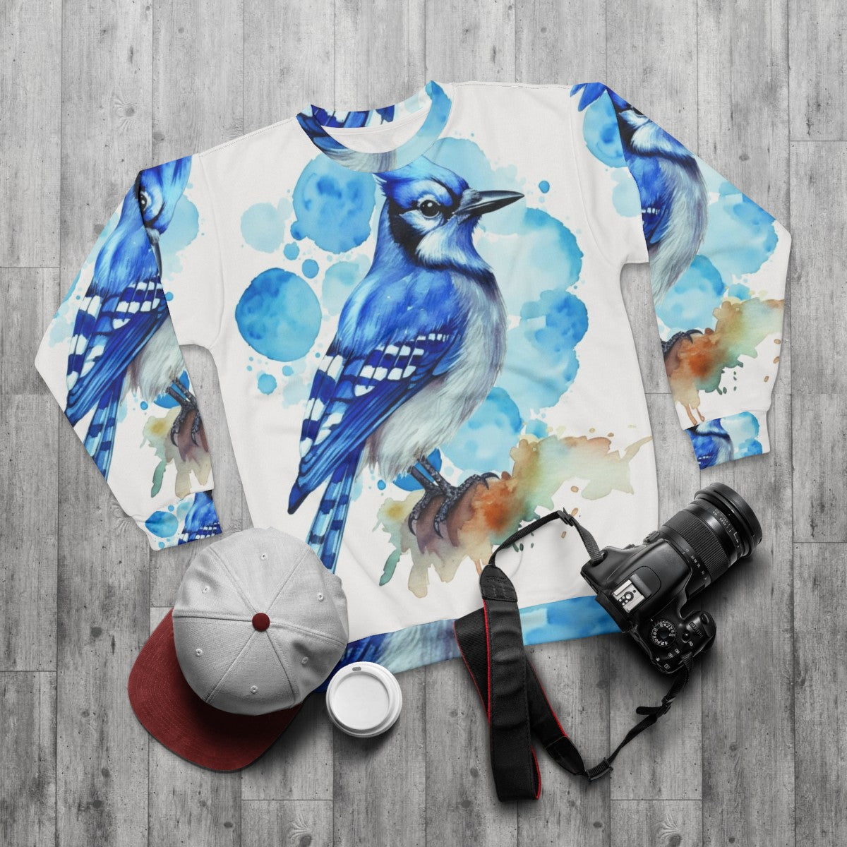 Closeup of a stylish blue jay sweatshirt with watercolor design - flat lay