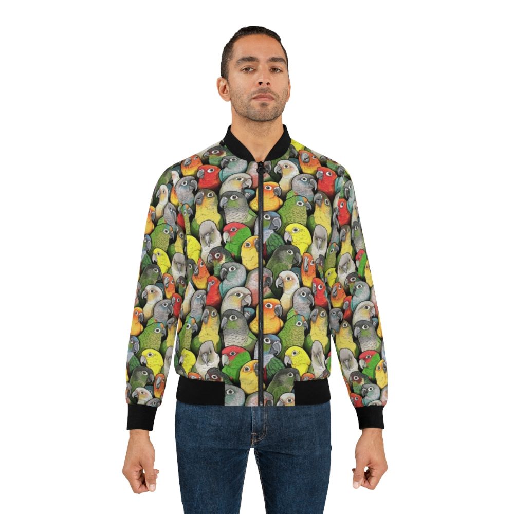 Colorful bomber jacket with a pattern featuring various conure species, including scarlet, crimson, peach faced, pineapple, and yellow sided conures. - Lifestyle