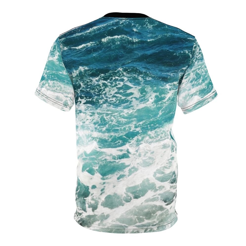 Model wearing a blue t-shirt with an abstract ocean waves pattern - Back