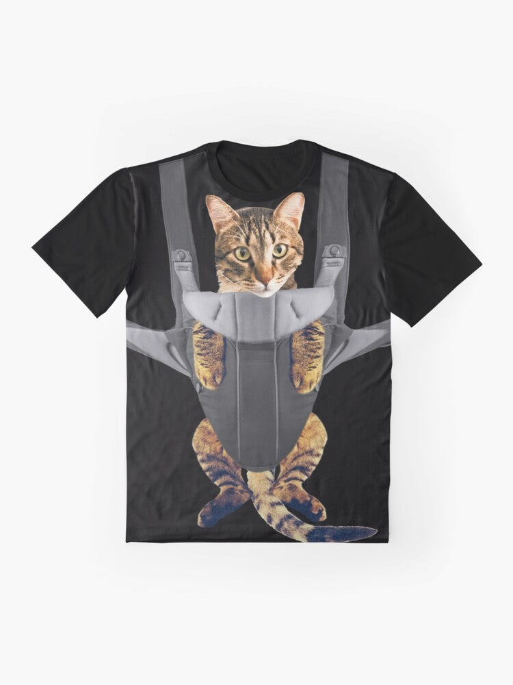 A funny graphic t-shirt design featuring a cat in a baby carrier. - Flat lay