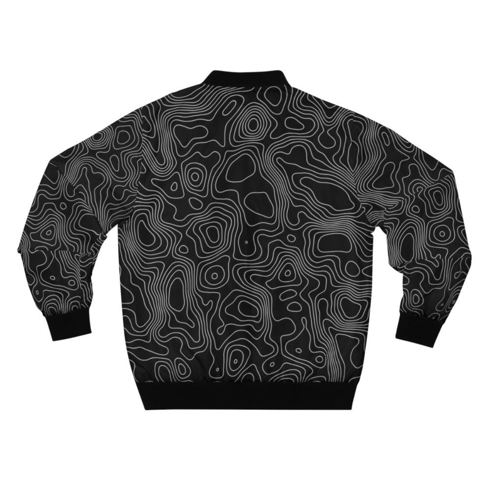 A minimalist bomber jacket featuring a topographic contour line abstract design in black and white. - Back