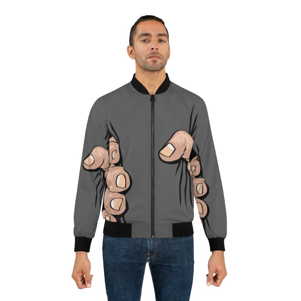 A bomber jacket featuring an illustration of a giant hand squeezing and grabbing the wearer. - Lifestyle