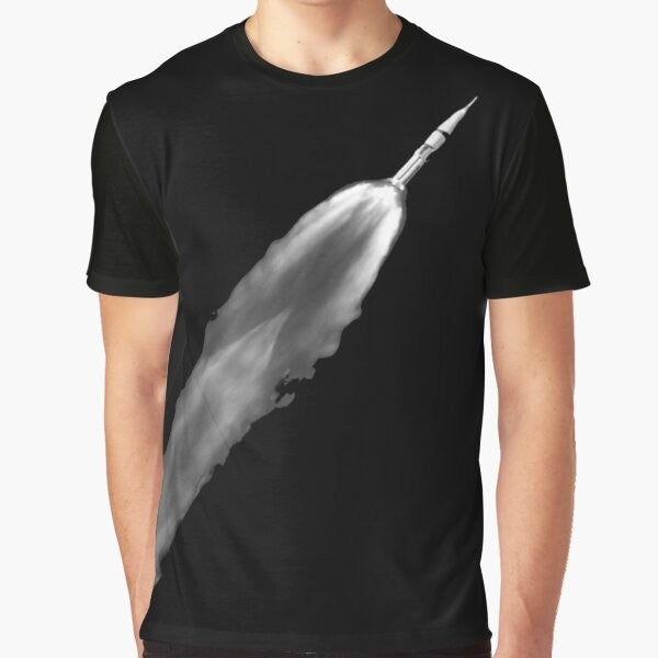 Graphic t-shirt with a rocket launch design, featuring the Saturn V rocket and space elements.