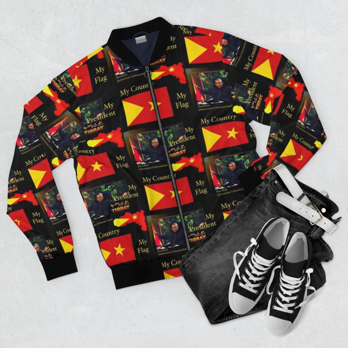 Tigray Pride Bomber Jacket featuring the Tigray flag and portrait of Debretsion Gebremichael - Flat lay