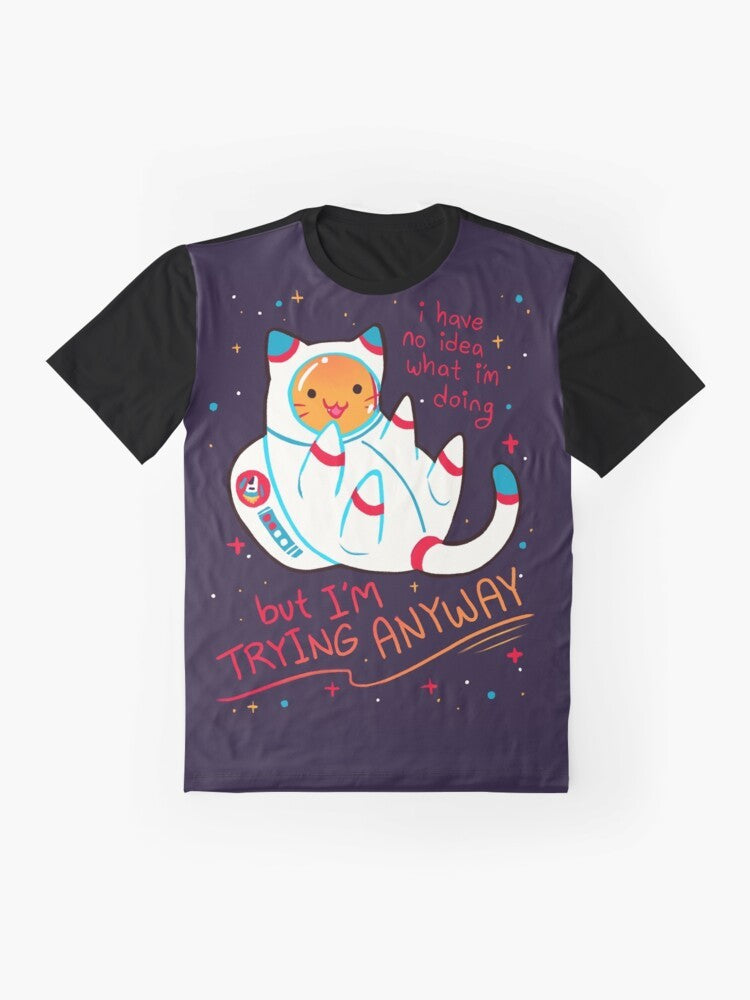 Catstronaut graphic t-shirt with the text "I'M TRYING ANYWAY" and stars in the background - Flat lay