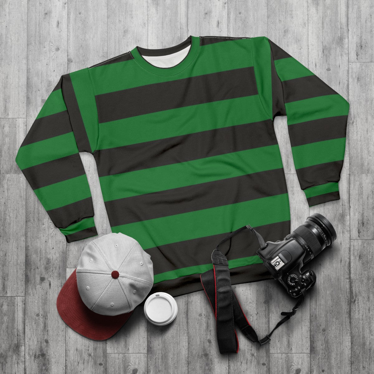 Green and striped sweatshirt with horizontal stripes - flat lay