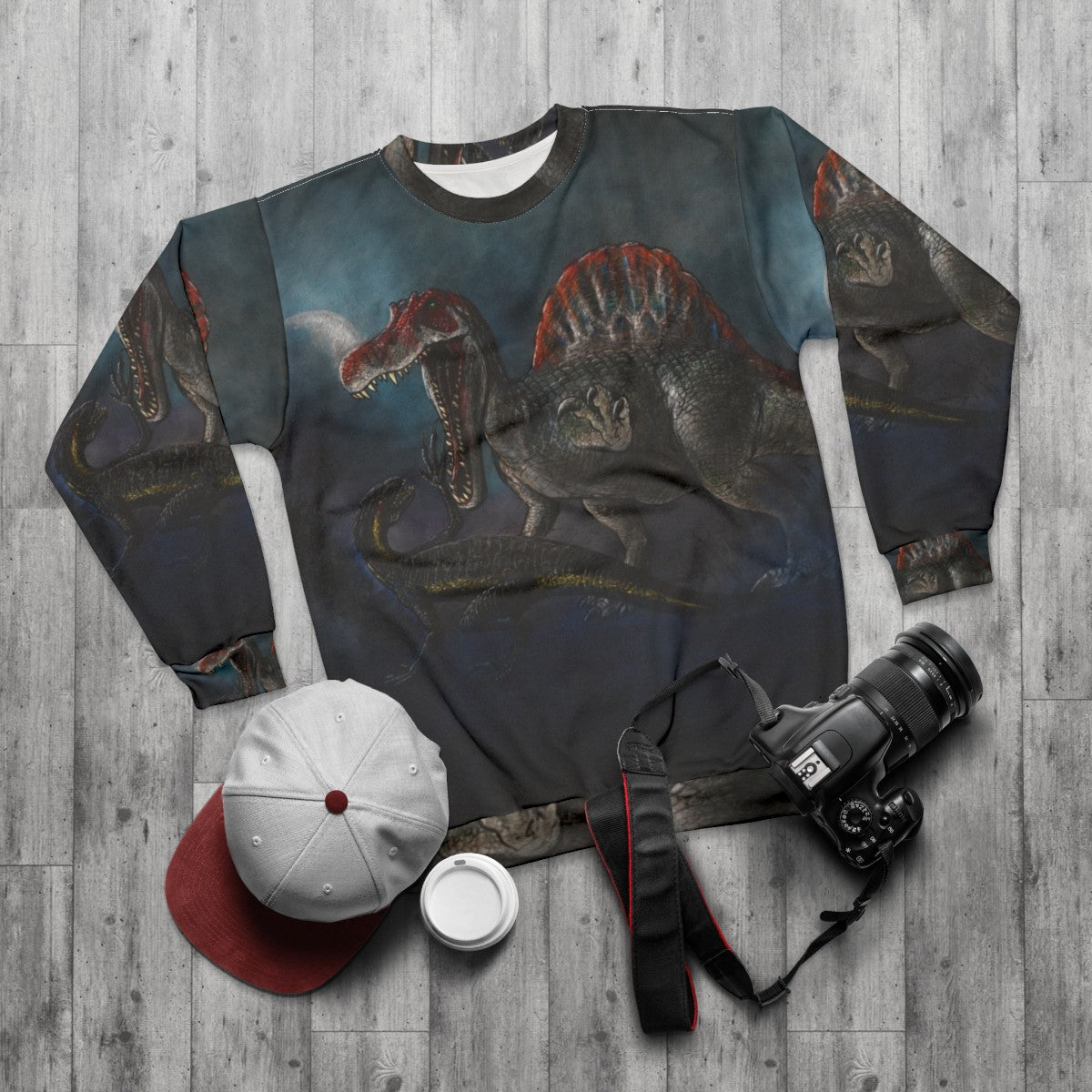 Spinosaurus vs Indominus Rex dinosaur battle graphic on a sweatshirt - flat lay