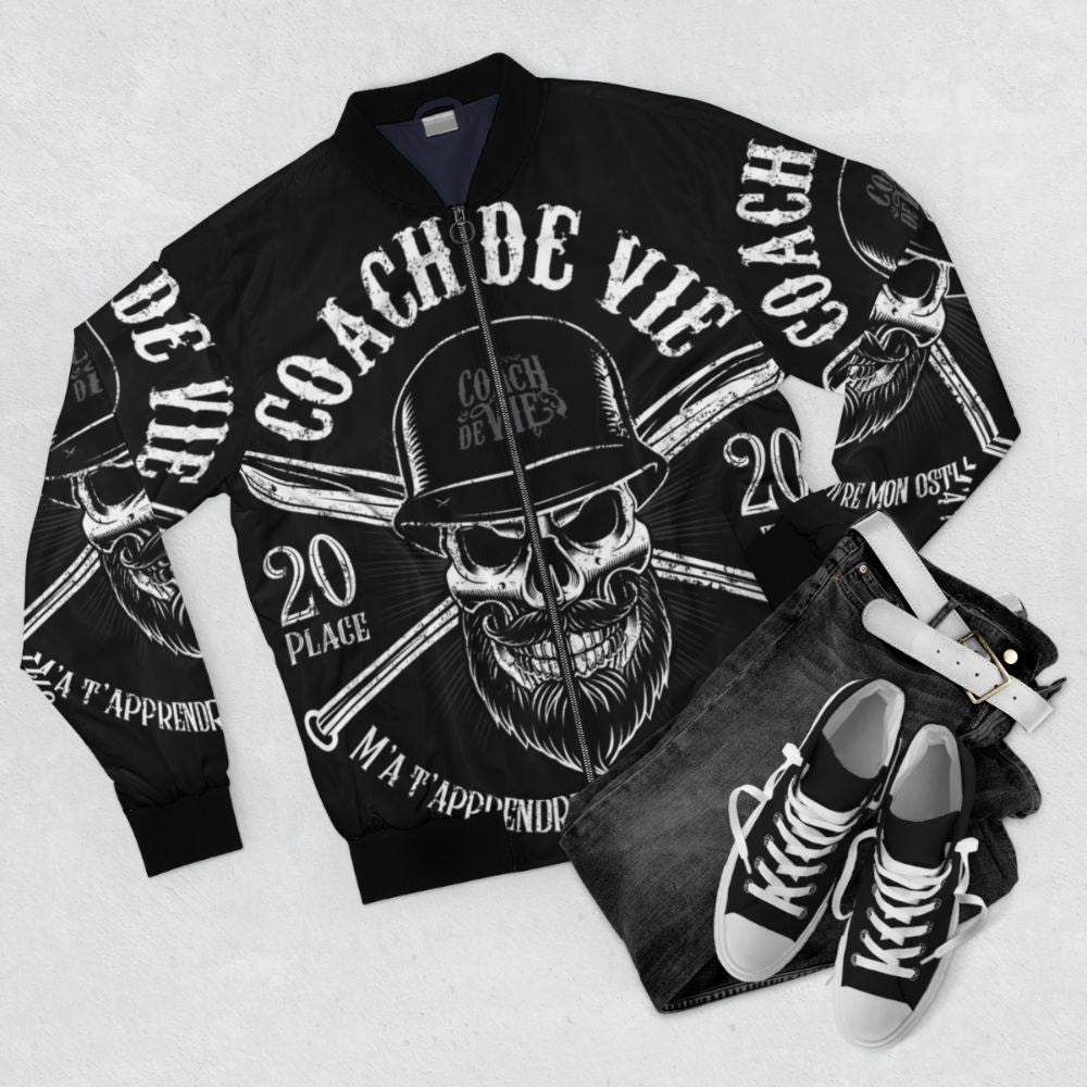 Biker bomber jacket with pop art design and "Teach Me How to Live My Osti!" life coach slogan - Flat lay