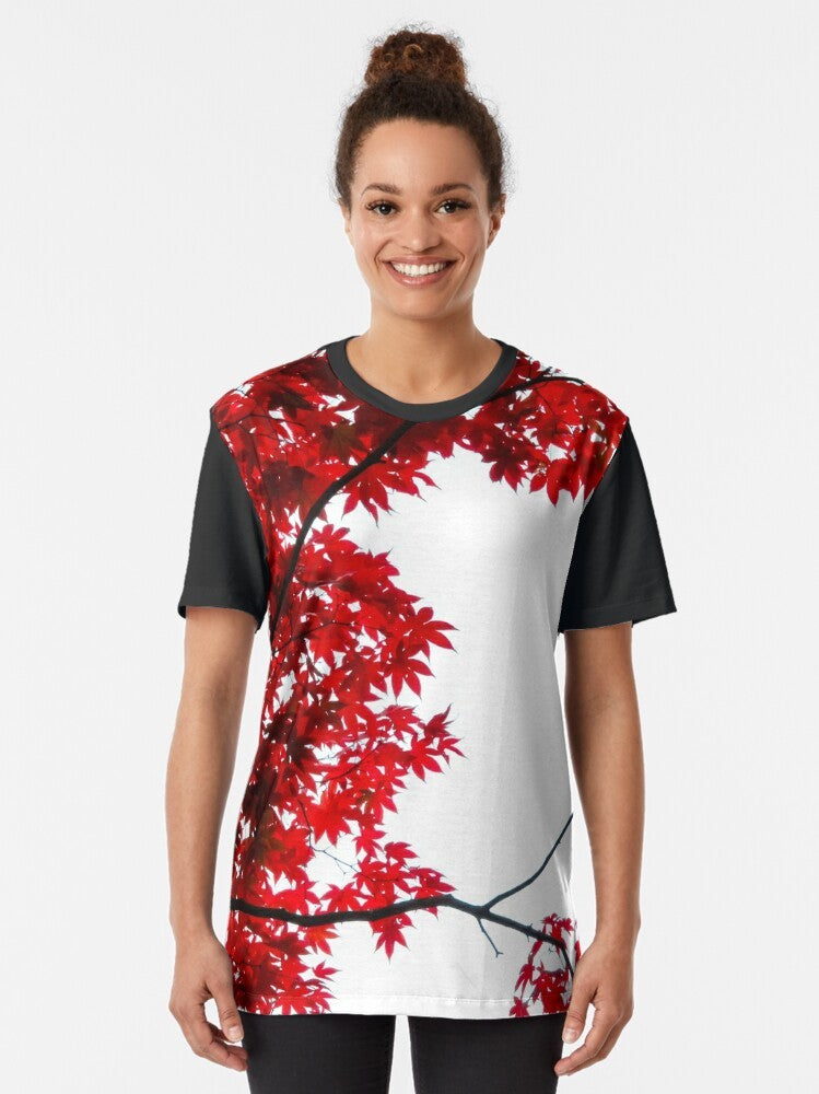 KOYO graphic t-shirt featuring a vibrant red Japanese maple leaf against a blue sky background - Women