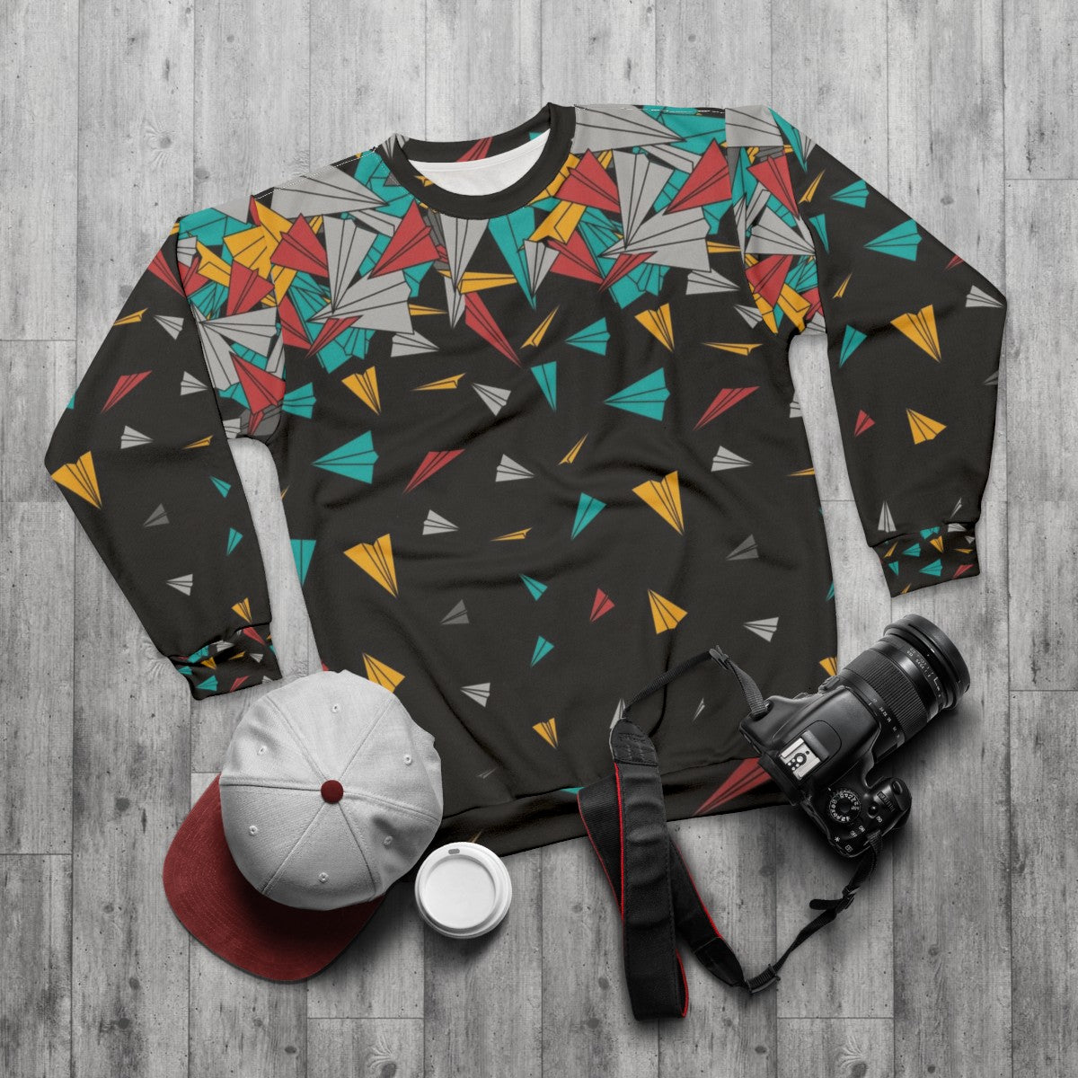 Geometric paper plane design on a colorful sweatshirt - flat lay