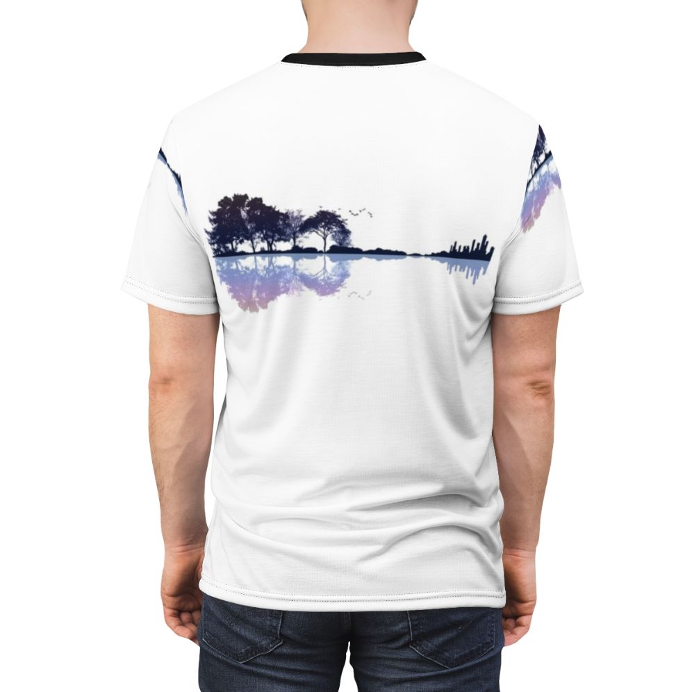 Artistic t-shirt design featuring a silhouetted guitar surrounded by a natural landscape with trees, water, and birds. - men back