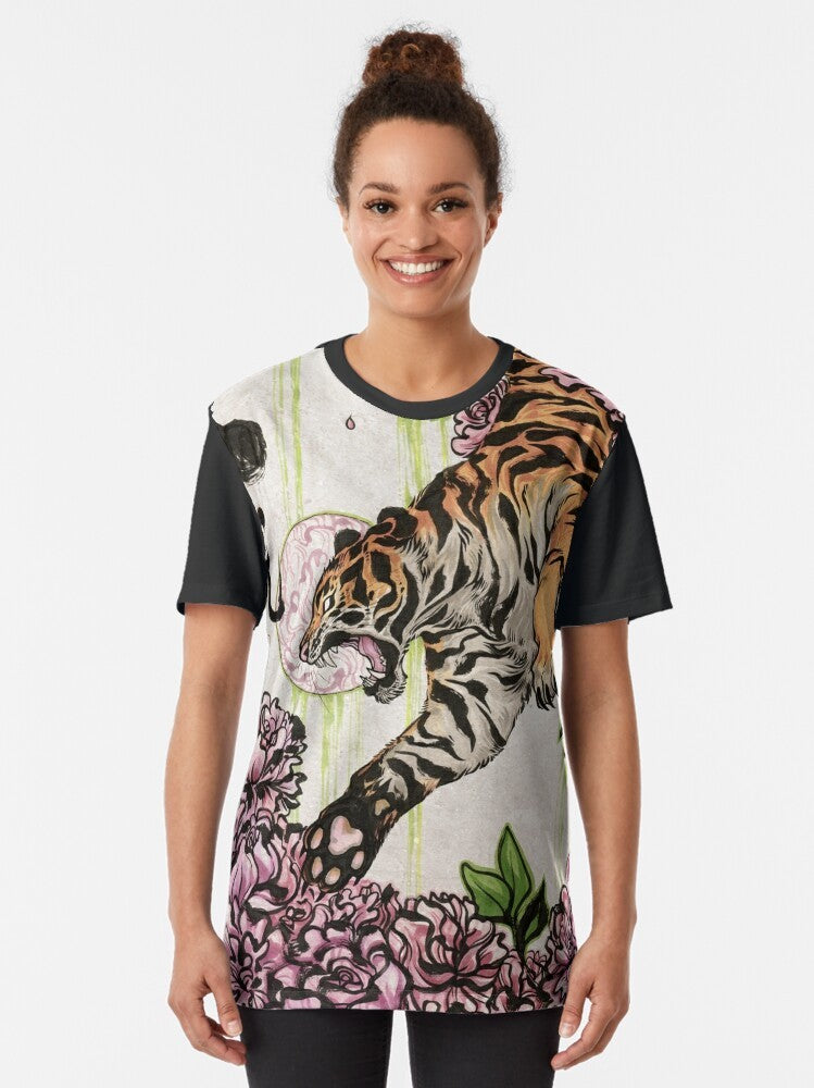 A graphic t-shirt featuring a tiger design with Chinese-inspired brush strokes and peonies. - Women