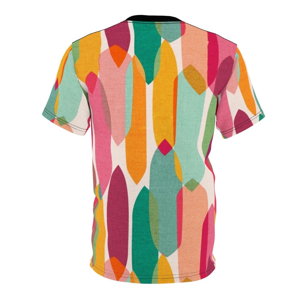 Model wearing a t-shirt featuring a vibrant mid century modern inspired abstract droplet pattern in a colorful kaleidoscope design - Back