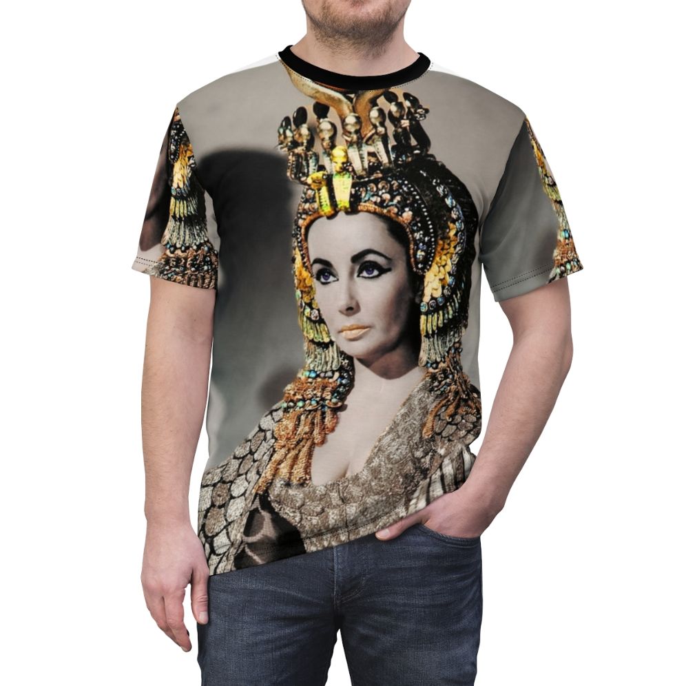 A person wearing a T-shirt featuring a stylized portrait of Elizabeth Taylor as Cleopatra in ancient Egyptian attire. - men front